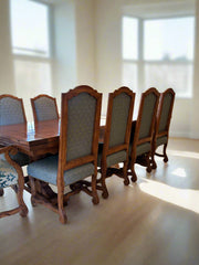 Wooden dining table with chairs in a bright room